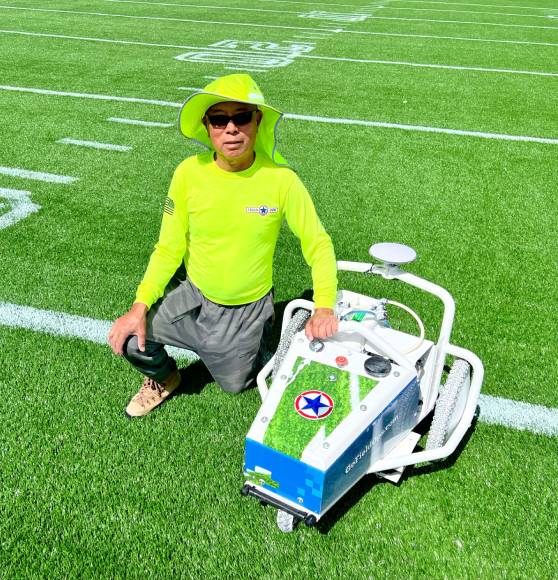 field ops san antonio owner with football field painting machine