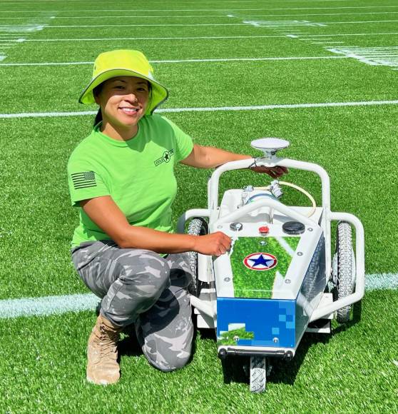 field ops san antonio employee next to tool to paint football fields